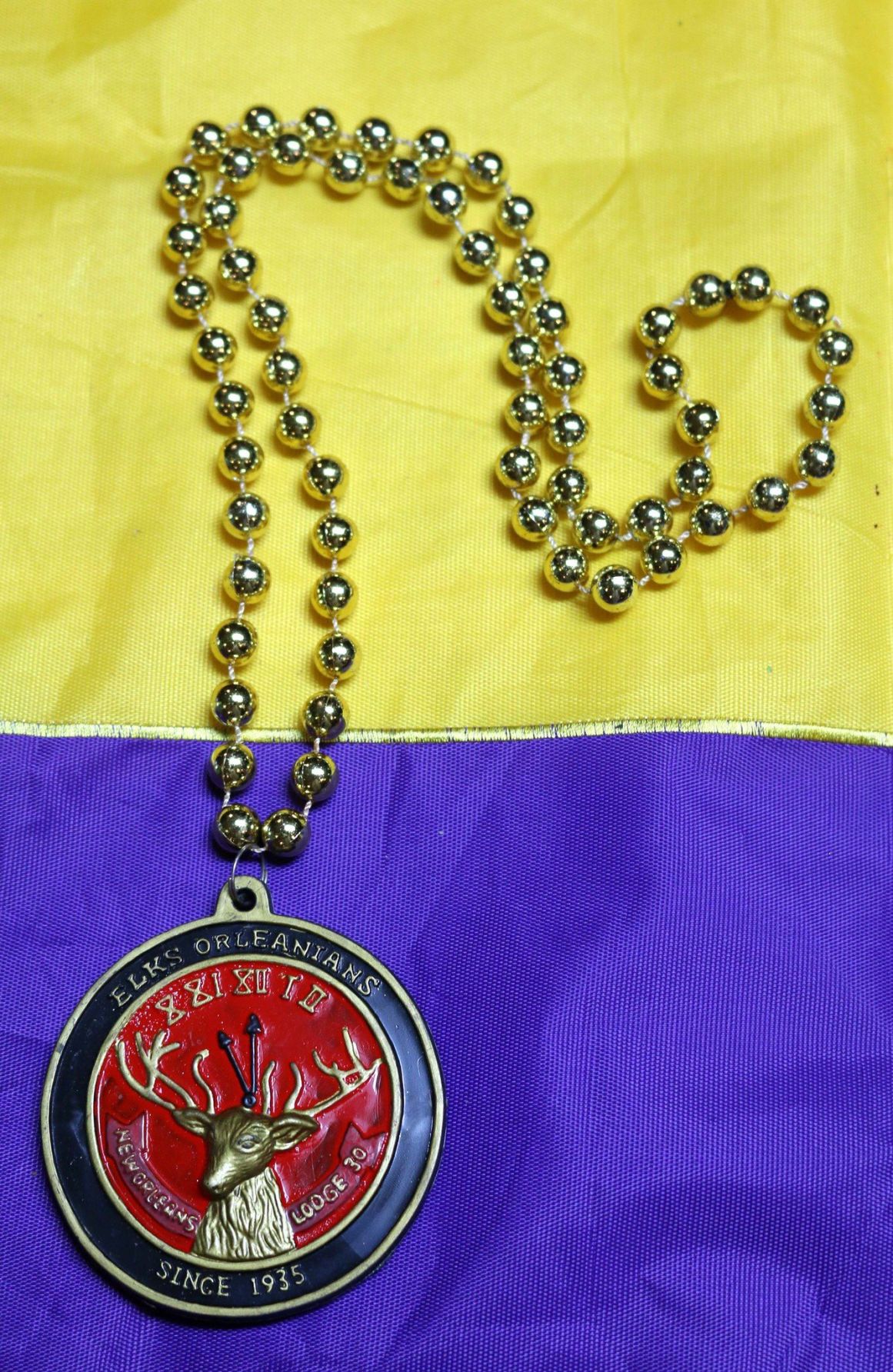 Krewe of Elks Orleans throws: Elroy the Elk, footballs and medallions